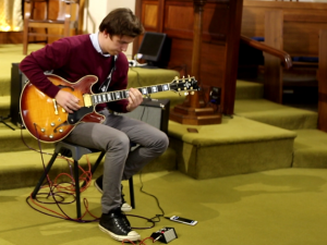 Student performing on electric guitar