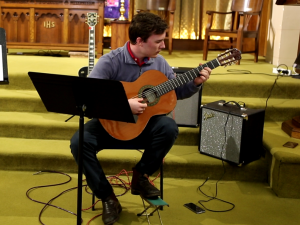 Student performing on Guitar